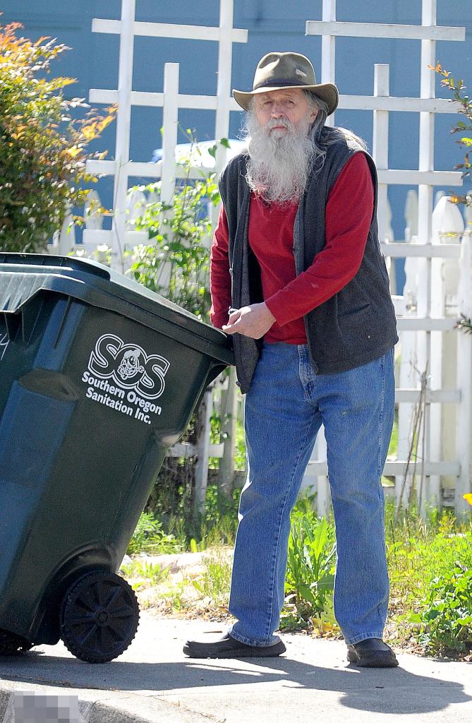 Kit Culkin wheels a trash can outside his home in Oregon.