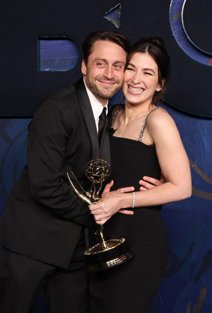 Kieran Culkin hugs Jazz Charton as she holds his Emmys trophy