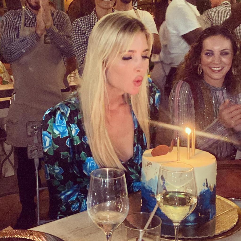 Ivanka Trump blowing out a birthday cake.